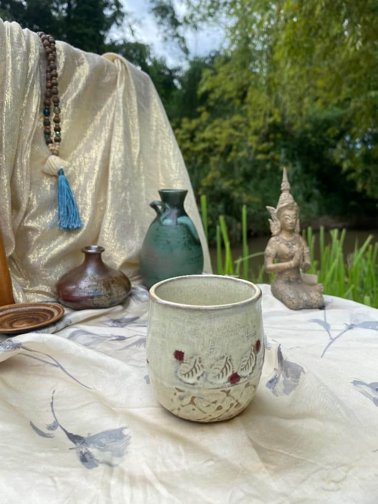 Cream cup with raised leaf and berry relief