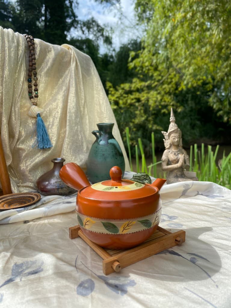 Orange kyusu teapot with a painted leaf band